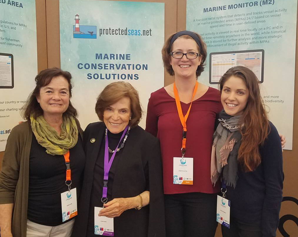 Lawyers from the Earth Law Center stand in front of a presentation on Marine Conservation Solutions.