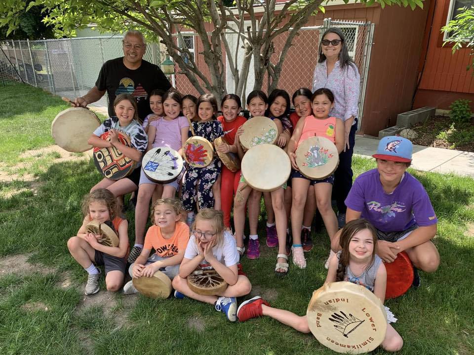 Native children and their teachers gathered for a photo.
