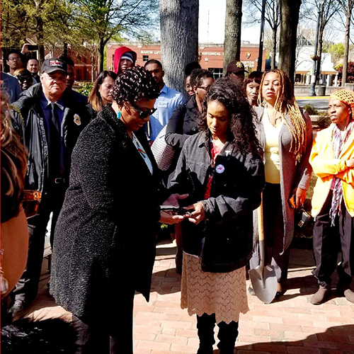 brontë velez hands Dr. Bernice King a gun to be delivered to the furnace on the 50th anniversary of her father’s assassination.