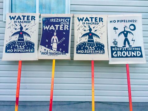 Signs with Water Is Life slogans.