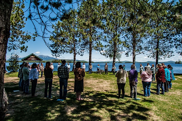 Wabanaki Chiefs, natural resource directors, and conservation leaders meet facing Mount Katahdin