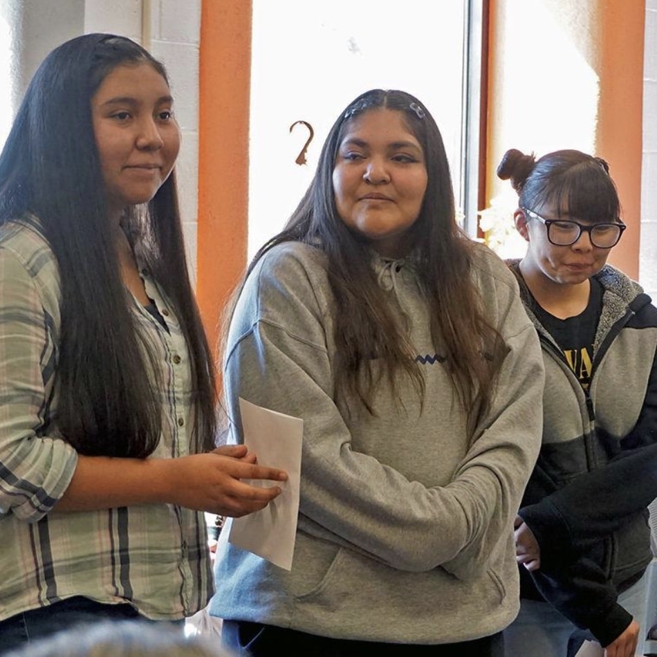 Three Native women standing.
