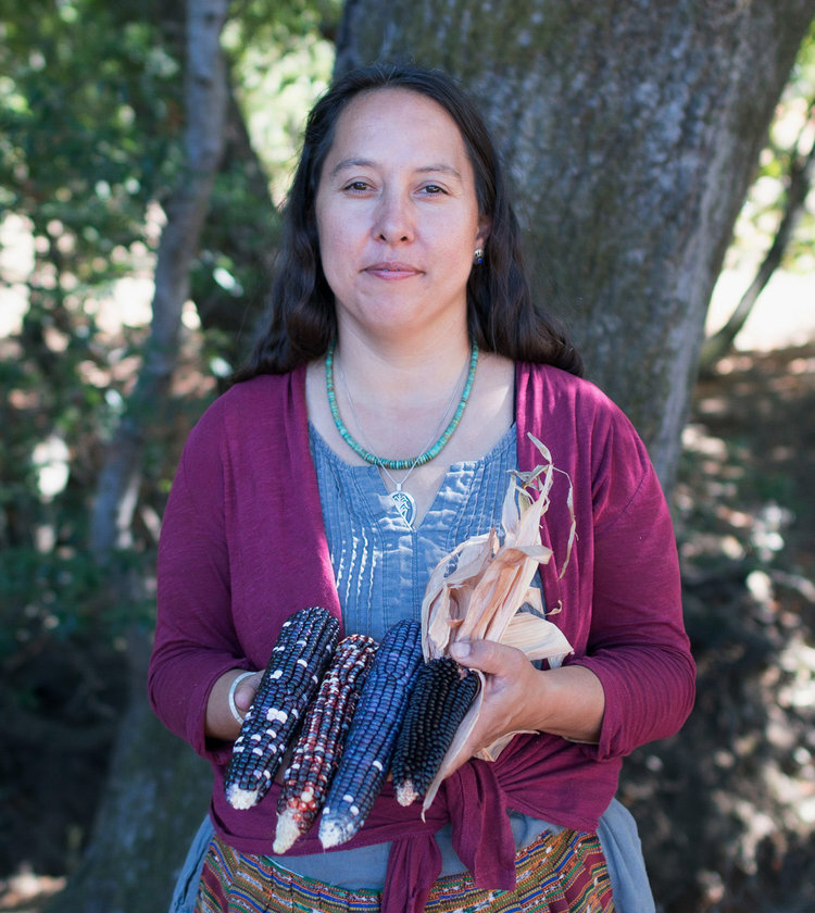 Portrait of Rowan White holding ears of Native corn.