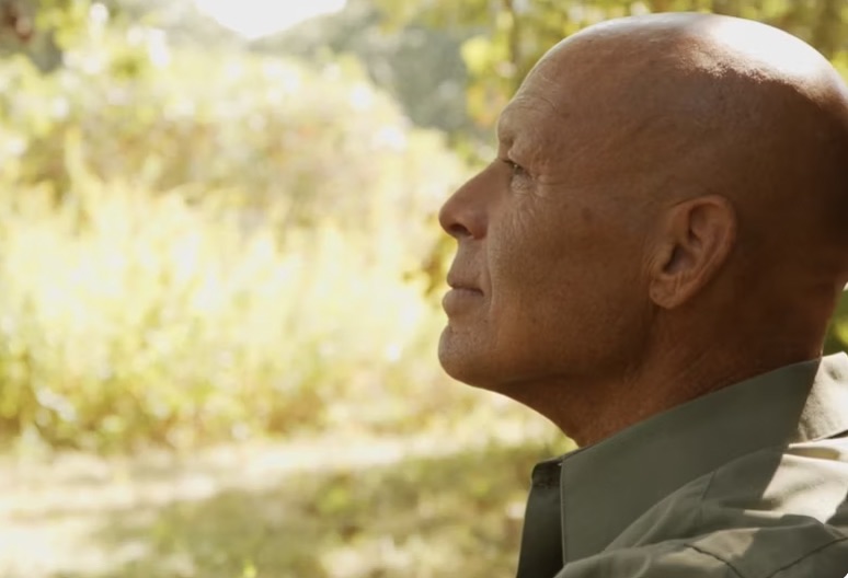 Bald man in profile.